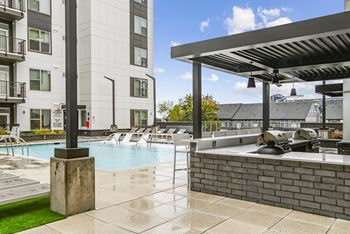 spa and grilling area with buildings at Link Apartments® Mint Street, North Carolina